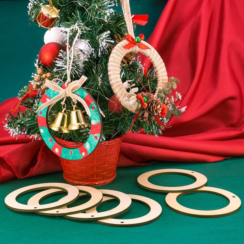 Decorative Christmas wreaths with bells on a small tree against a red fabric background
