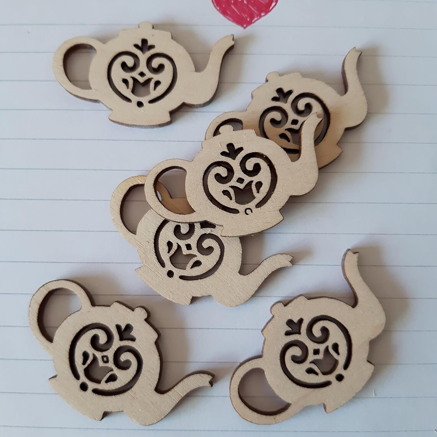 Wooden coasters with teapot design on a lined paper background