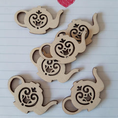 Wooden coasters with teapot design on a lined paper background
