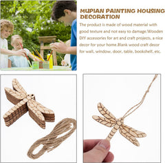 Wooden dragonfly decorations with string, children painting in the background.