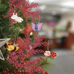 Decorative Christmas tree with colorful insect ornaments on red branches.