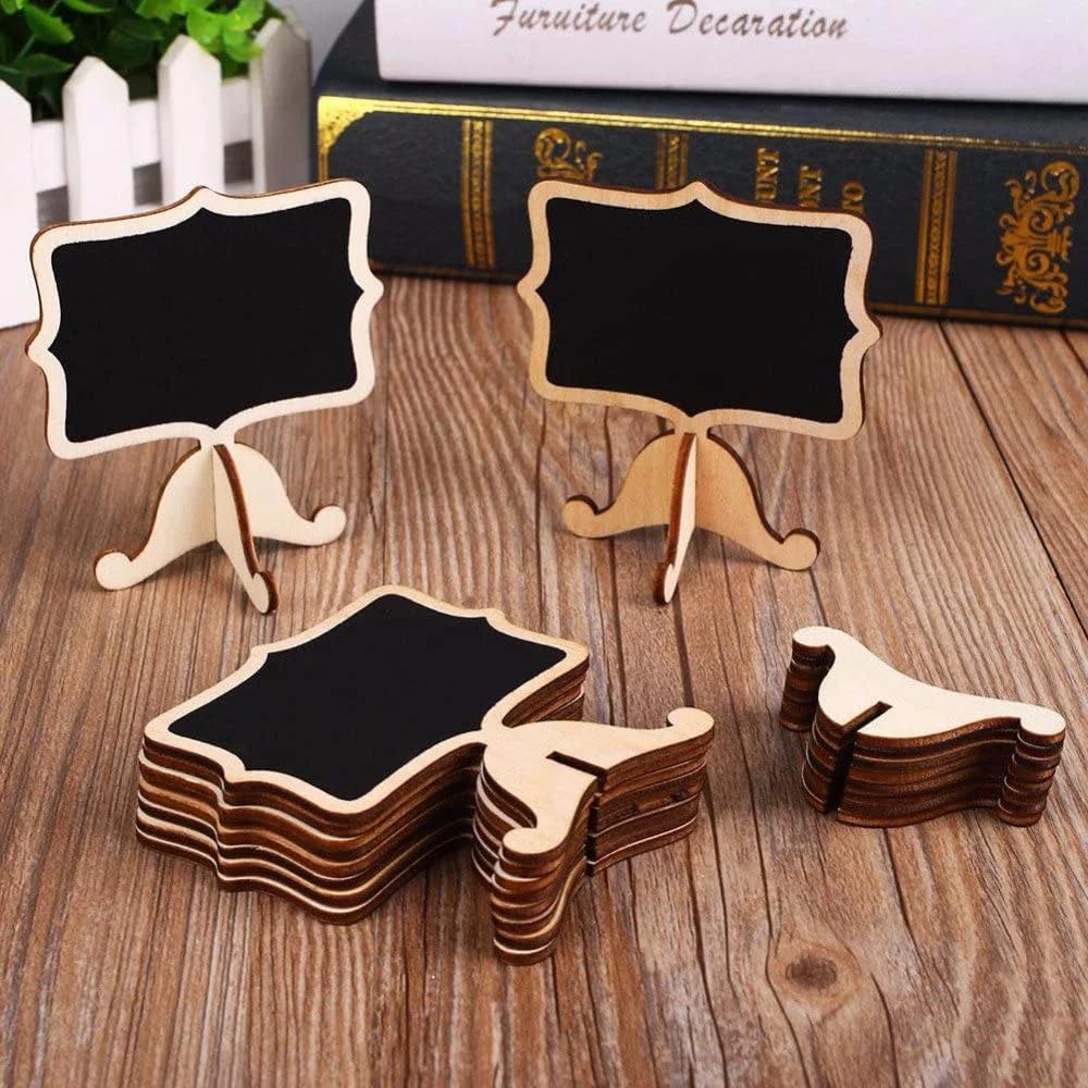 Small blackboards with stands on a wooden surface