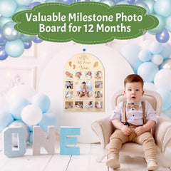 Baby milestone photo board with balloons and a child in formal attire.