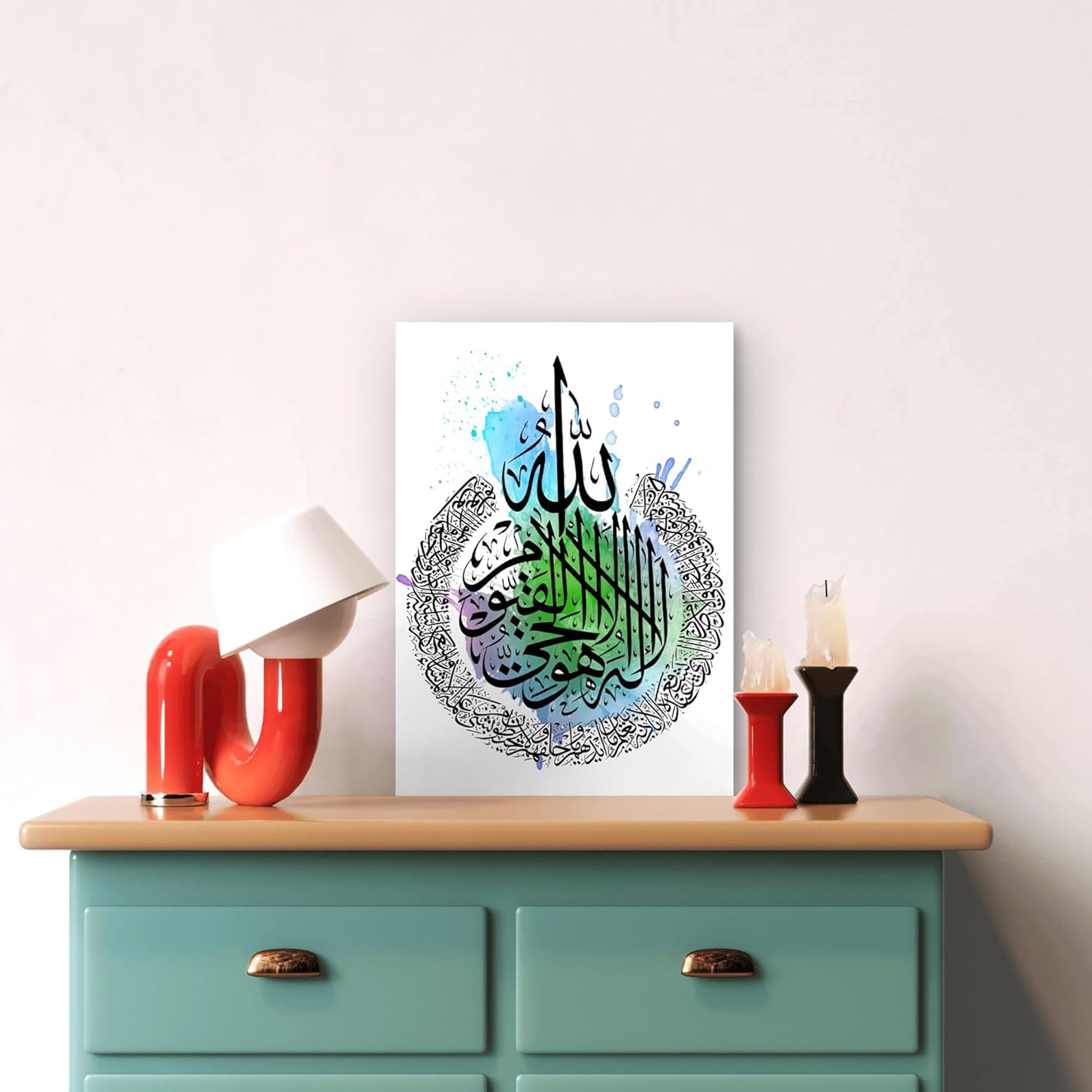 Decorative wall art with Arabic calligraphy on a light blue dresser.