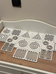 Set of geometric patterned tiles on a wooden surface