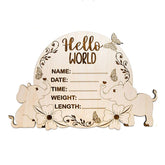 Wooden plaque with elephant designs and text fields for baby details on a white background