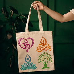 Tote bag with yoga-themed designs held by a hand against a dark green background