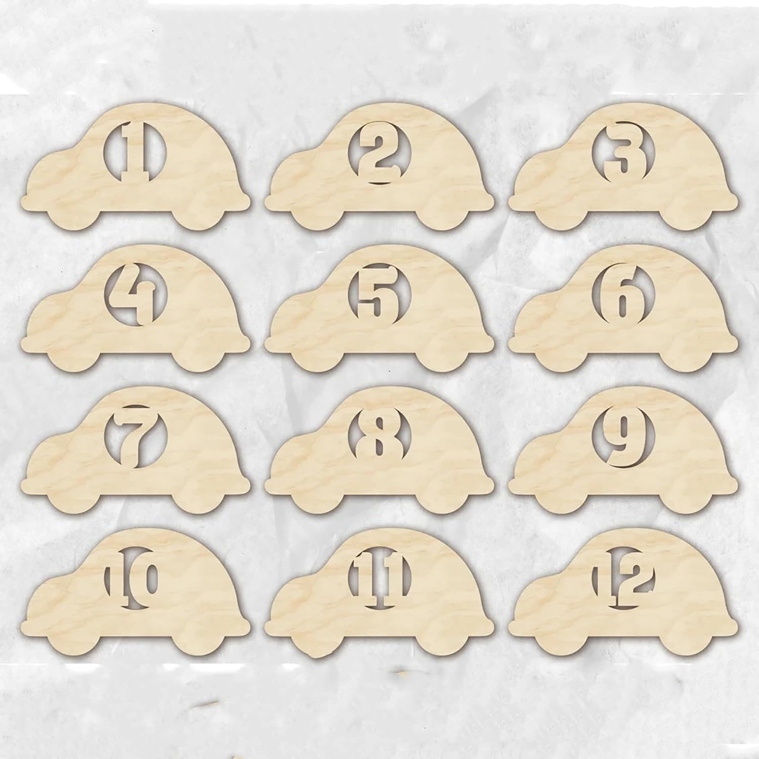 Set of 12 wooden car-shaped number cards on a light background