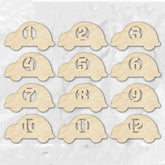 Set of 12 wooden car-shaped number cards on a light background