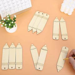 Wooden pencil-shaped bookmarks on a peach-colored surface with a hand holding a pencil.