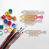 Wooden 'Happy Holi' signs with paint cans and brushes on a white background