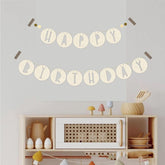 Happy Birthday banner on a wall above a shelf with decorative items.