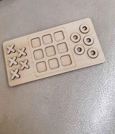 Wooden puzzle with square and circular pieces on a metallic surface