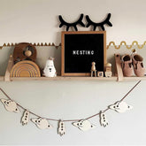 Nursery shelf with decorative items including a blackboard, wooden toys, and a banner.