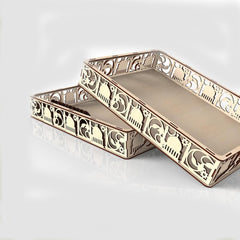 Decorative gold tray with intricate patterns on a white background