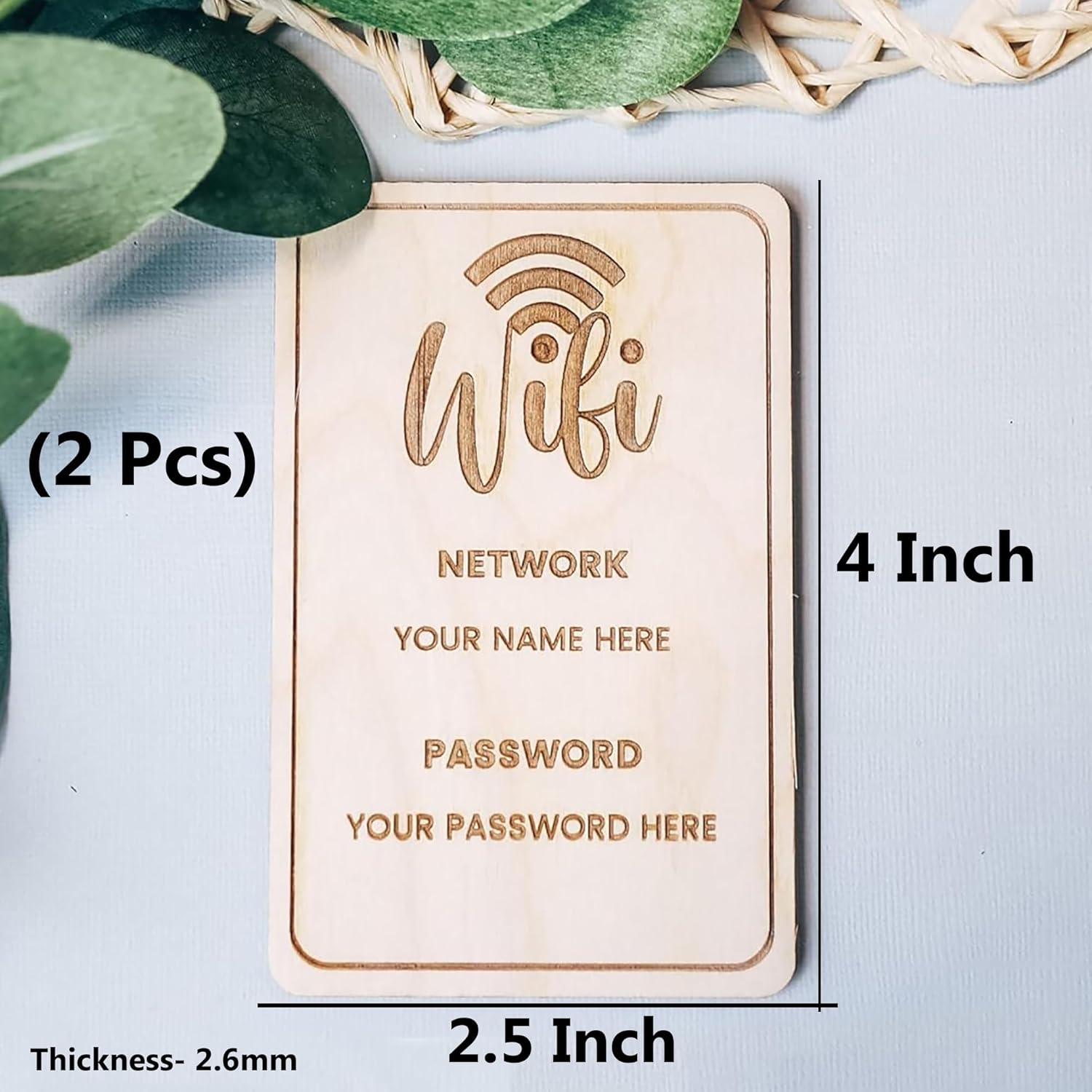 Wooden plaque with engraved text for WiFi network name and password on a light blue background.