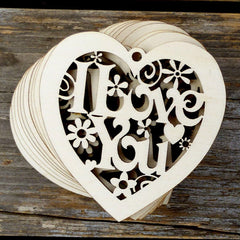 Wooden heart-shaped cutout with 'I Love You' text on a wooden surface