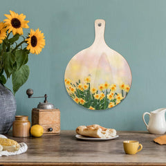 Decorative wall art with a floral design on a wooden surface with kitchen items.
