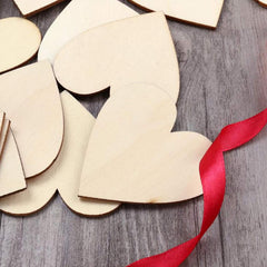 Wooden heart shapes with a red ribbon on a wooden surface