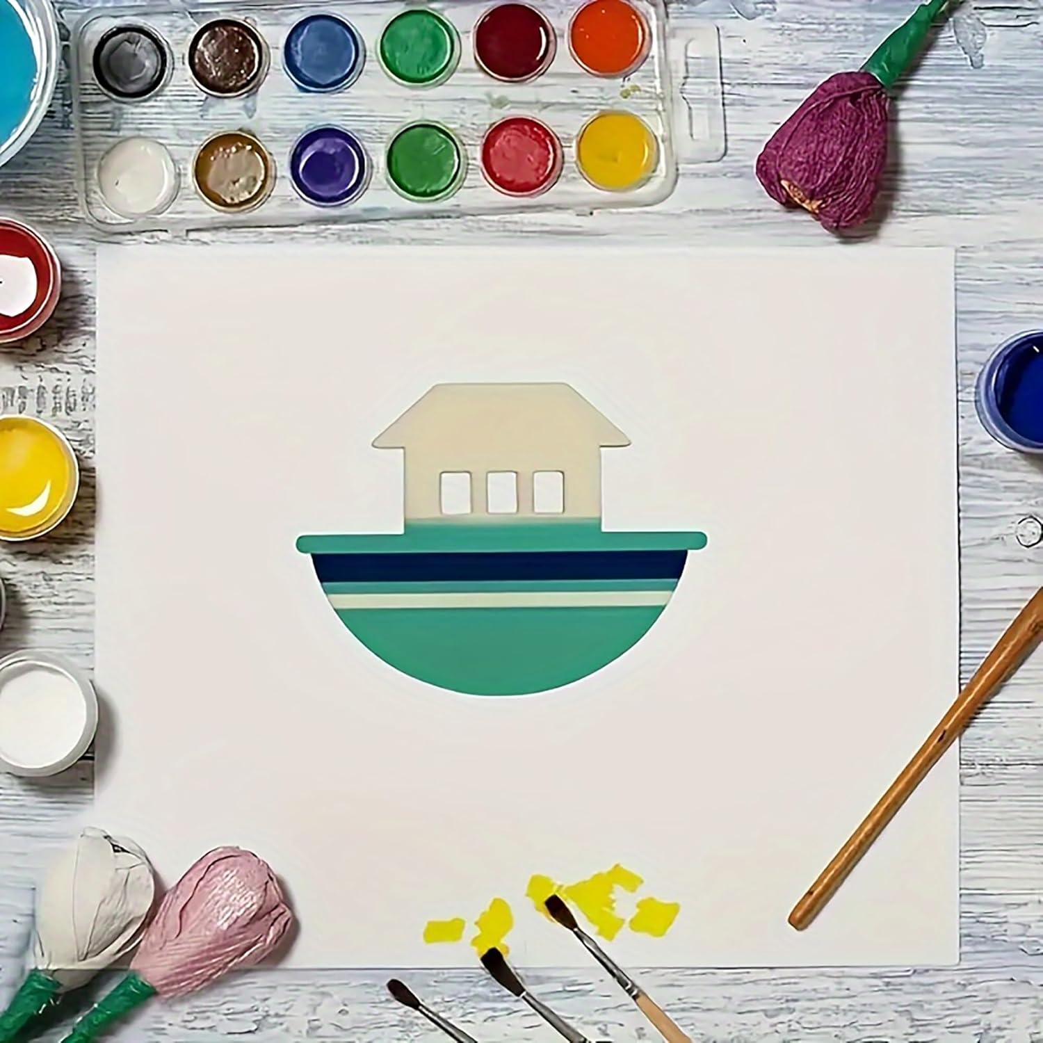 Artistic depiction of a houseboat with watercolor paints and brushes on a wooden surface.