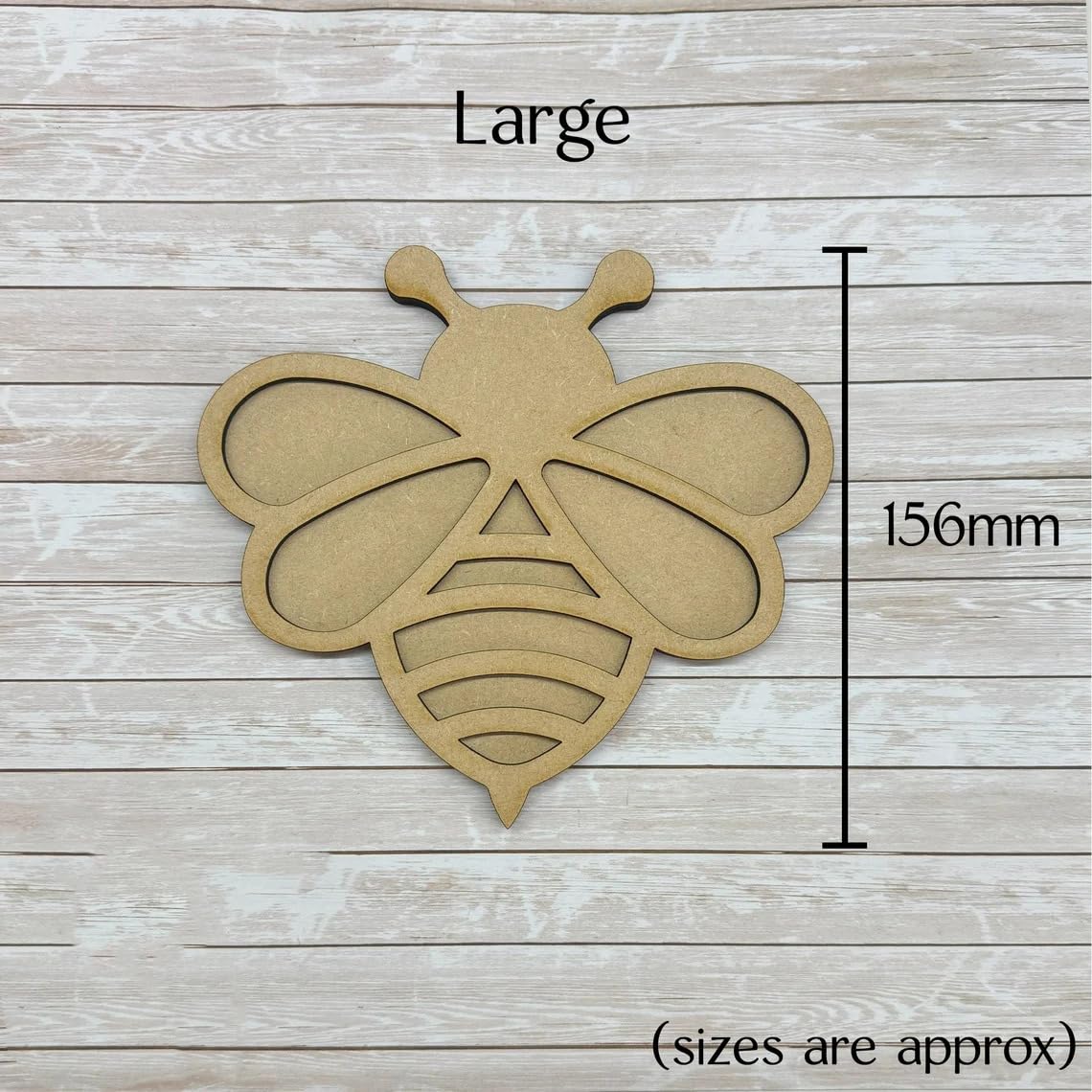 Large bee-shaped wooden cutout with dimensions on a wooden surface