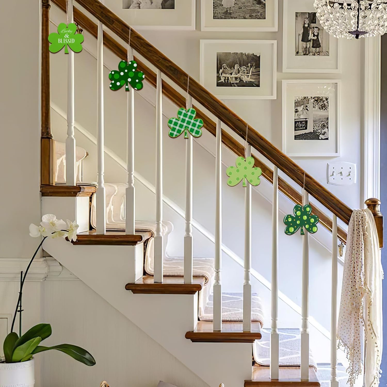 Staircase with green shamrock decorations and framed photos on the wall.