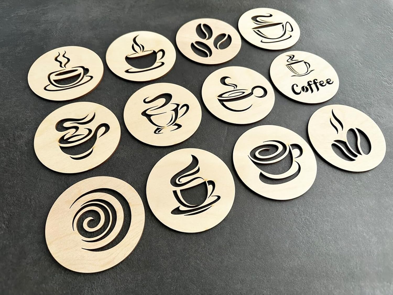 Set of wooden coffee-themed coasters with various designs on a dark surface