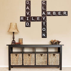 Wall with Scrabble tile wall art above a console table with wicker baskets.