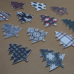 Collection of decorative leaf-shaped tiles with various patterns on a brown background