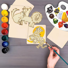 Wooden animal shapes with paint and a hand painting one of them on a wooden surface.