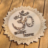 Decorative wooden plaque with Om symbol and 'sweet home' text on a wooden background