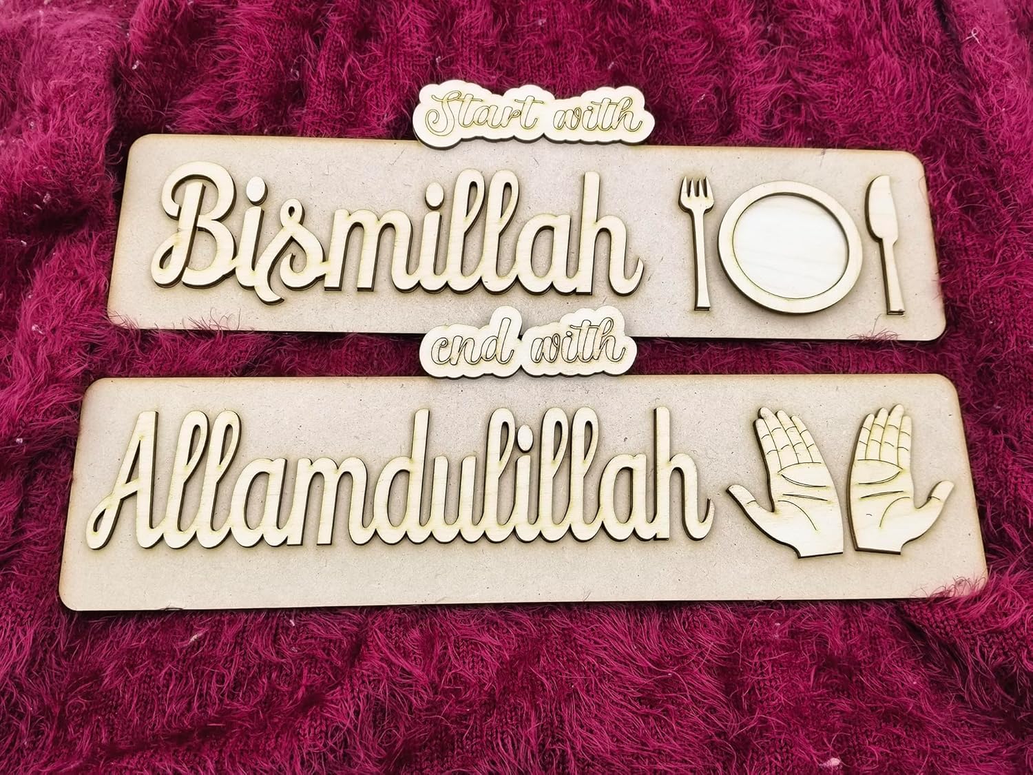 Two wooden signs with engraved text on a pink textured background
