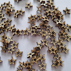 Wooden stars scattered on a white background