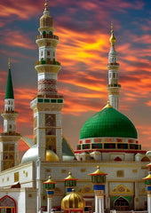 Decorative mosque with green dome and gold minarets against a vibrant sunset sky.