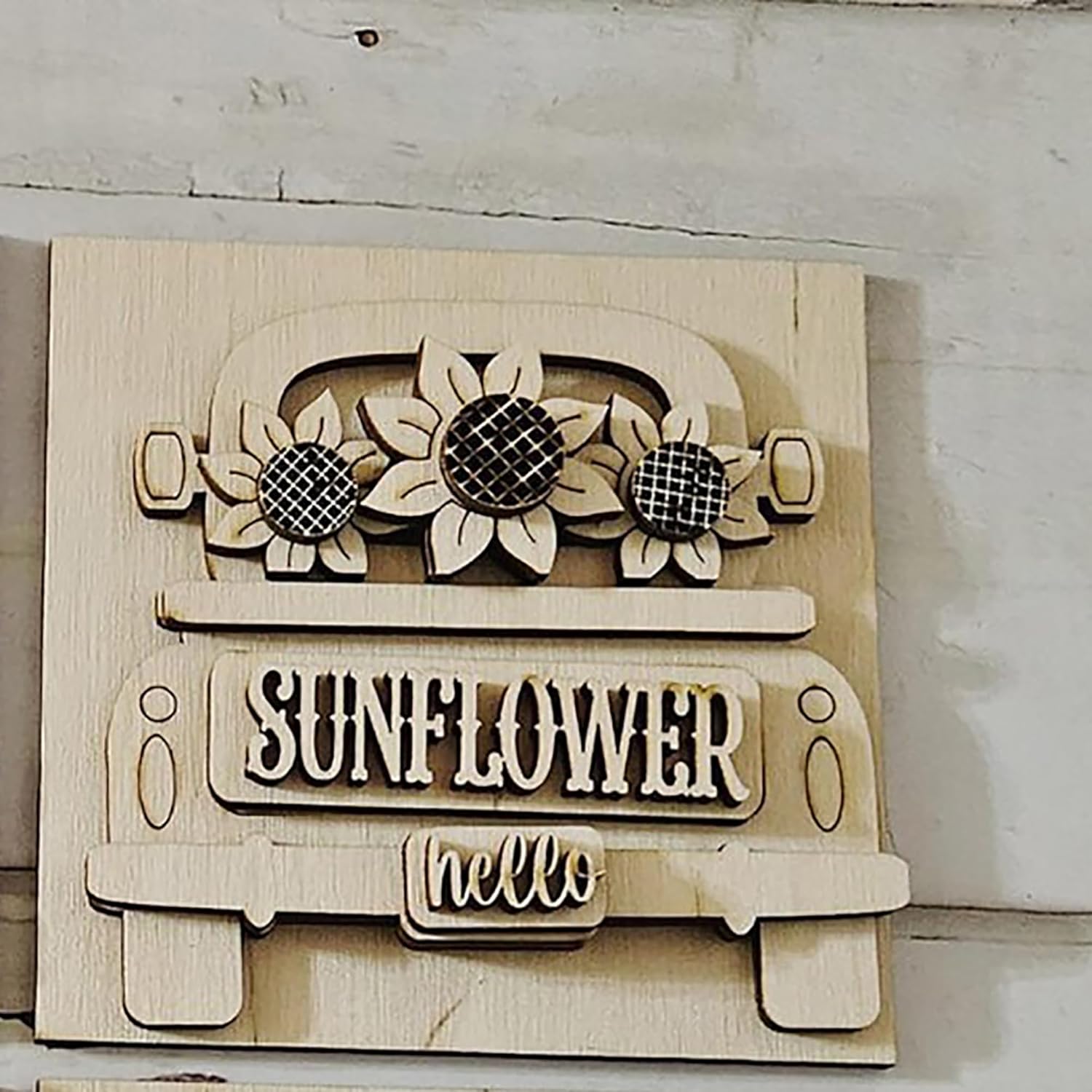 Wooden sign with sunflower design and 'Sunflower Hello' text on a light background