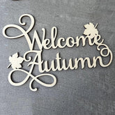 Decorative sign with 'Welcome Autumn' text on a gray background