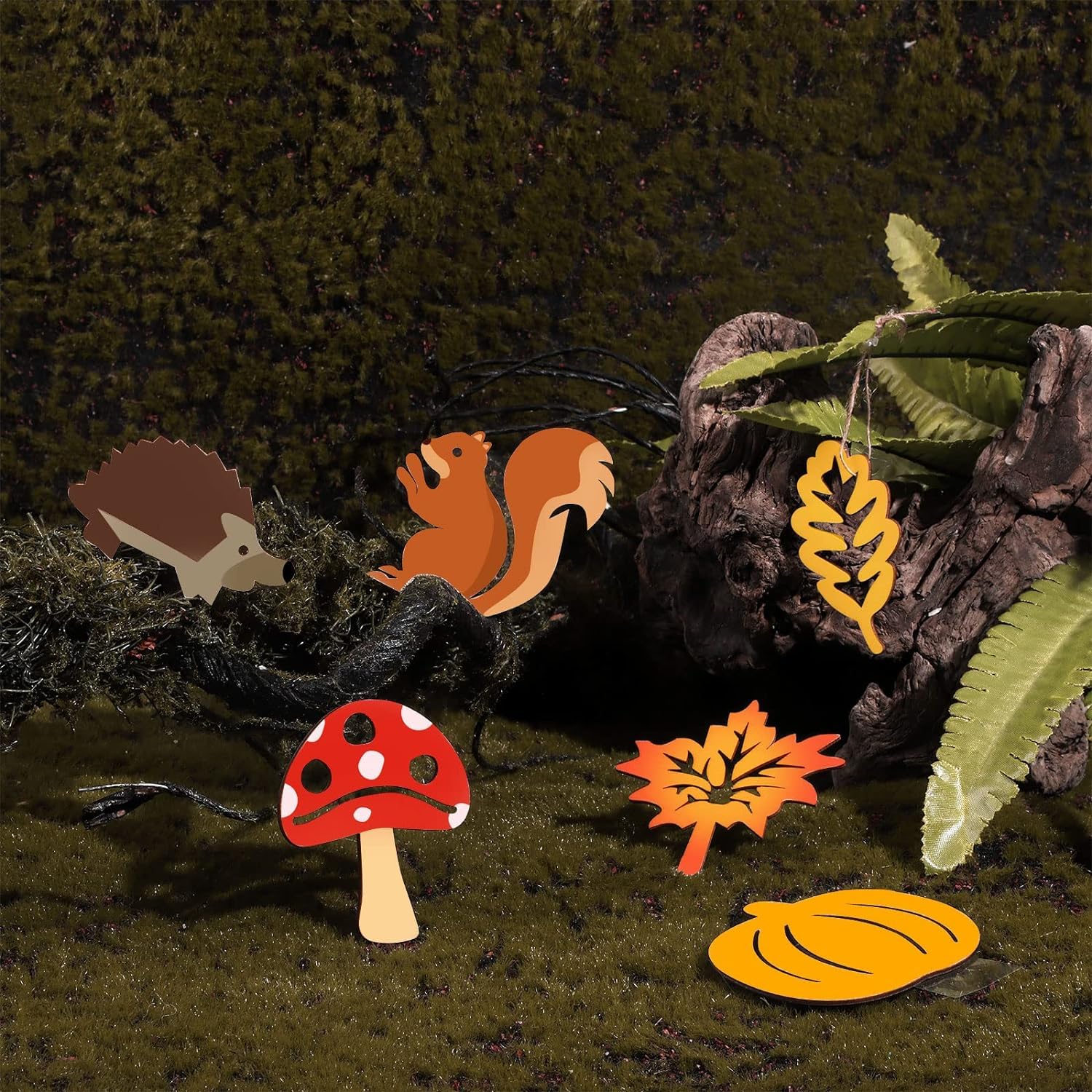 Decorative elements including a hedgehog, squirrel, mushroom, and leaves on a dark background