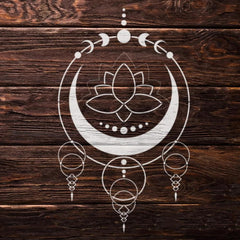 Decorative white symbol with lotus flower and crescent moon on a wooden background