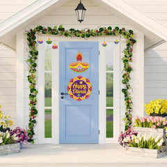 Decorated door with 'Happy Diwali' sign, floral garlands, and flower arrangements.