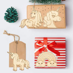 Wooden unicorn and rainbow decorations on gift boxes with a Christmas tree in the background.