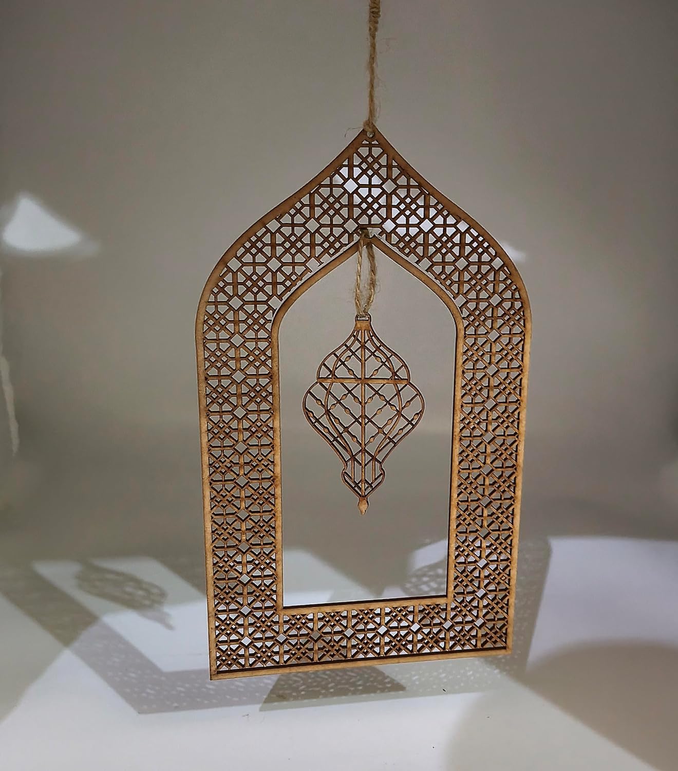 Decorative hanging item with intricate patterns on a neutral background