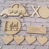 Wooden decorative items including hearts, 'LOVE', 'XO', 'FEB 14', and 'SMOOCH' on a brick wall background.