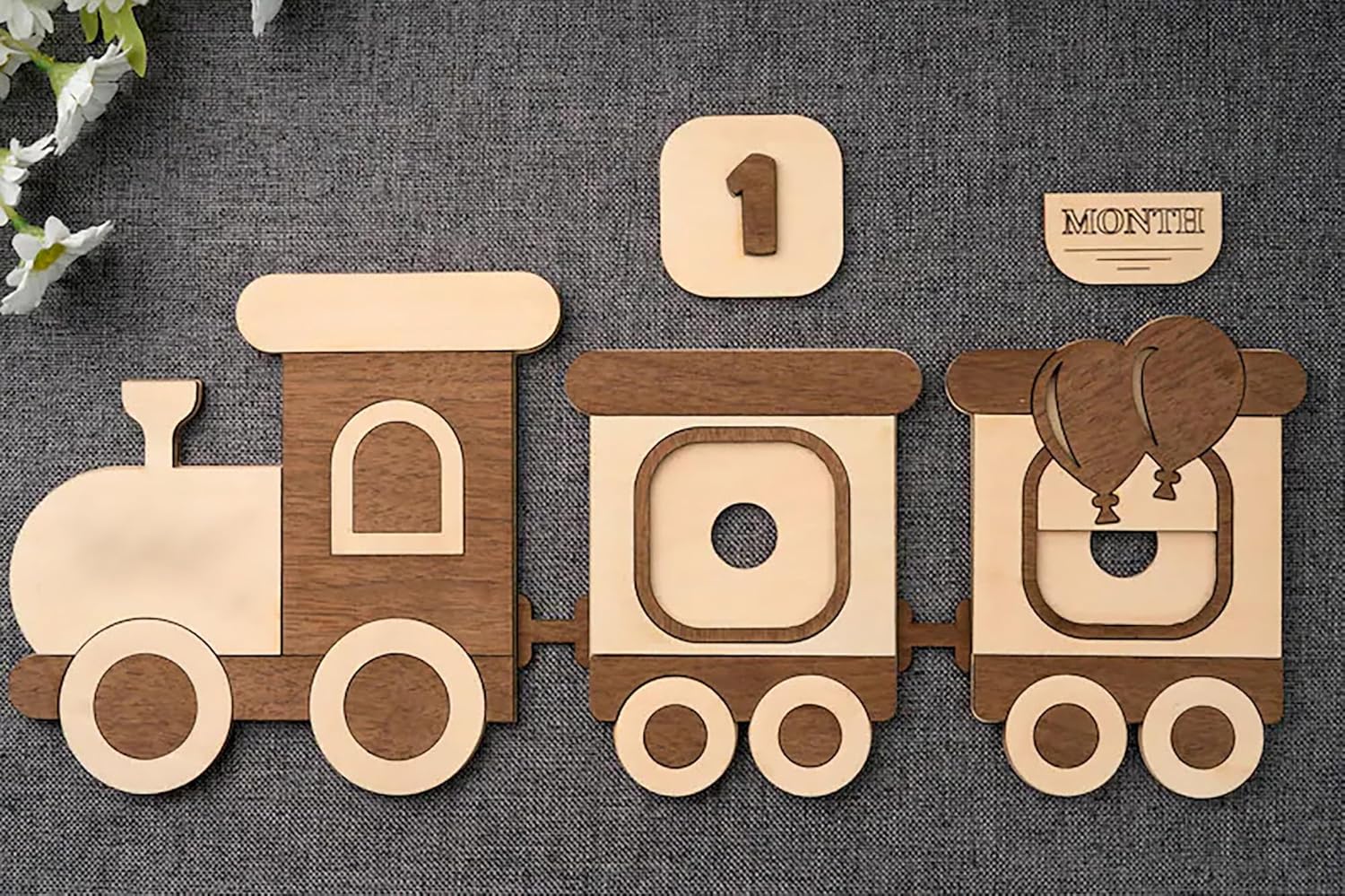 Wooden train toy with decorative elements on a textured surface