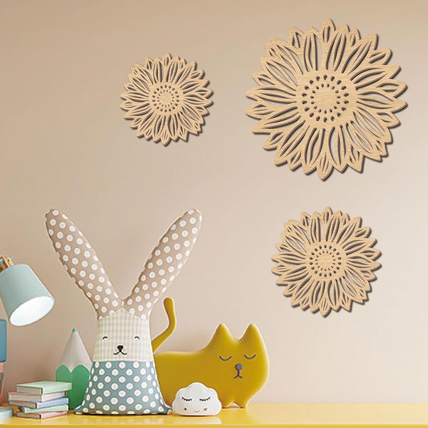 Decorative wall art with floral patterns on a beige wall above children's toys.