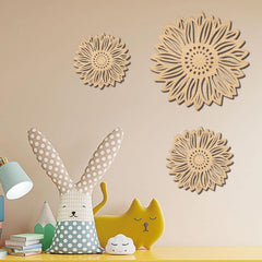 Decorative wall art with floral patterns on a beige wall above children's toys.