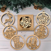 Wooden Christmas ornaments with intricate designs on a wooden surface with a box in the center.