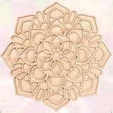 Decorative wooden mandala on a light pink background