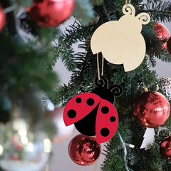 Decorative ladybug ornament on a Christmas tree with red baubles.