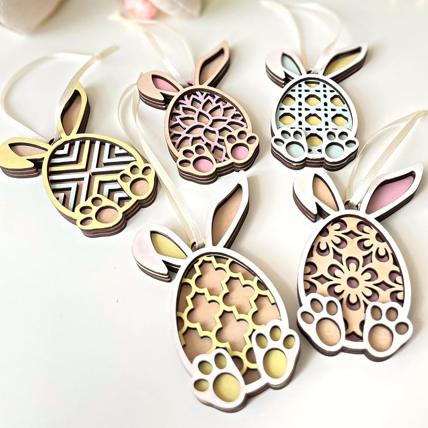 Decorative bunny-shaped ornaments with intricate patterns on a white background