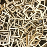 Pile of small wooden square frames on a dark surface